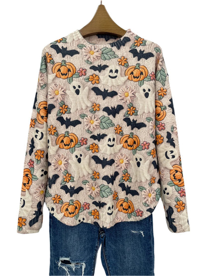 Halloween-themed sweater with pumpkins, ghosts, and bats on a hanger against a dark background.